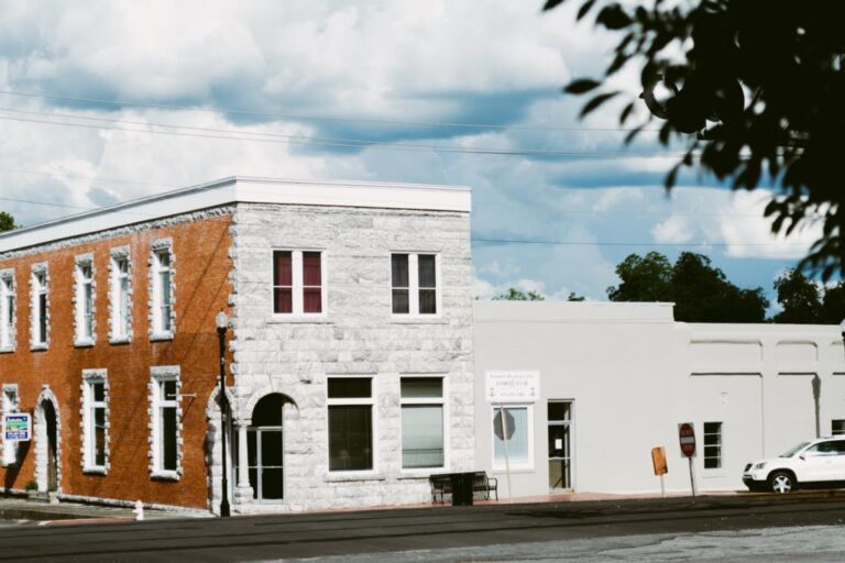 A two-storey red brick commercial building on a downtown Eastman corner
