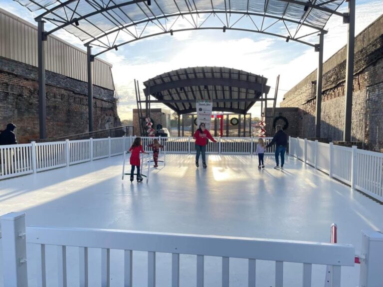 Families skating on the seasonal outdoor ice rink under the amphitheatre canopy