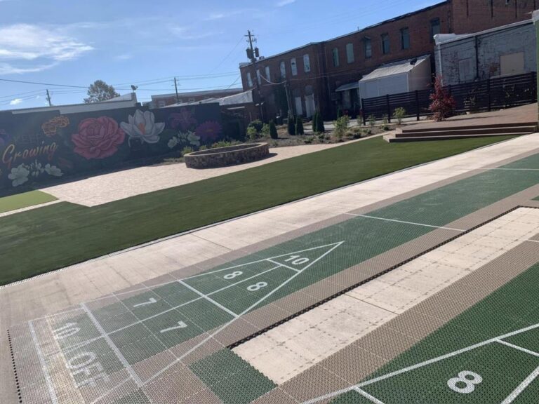 Shuffleboard courts and a painted flower mural in the downtown community park