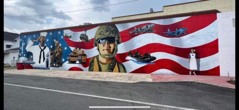A mural honouring members of the armed forces painted across a downtown wall