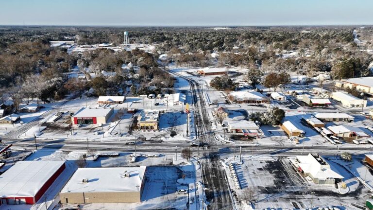 Aerial view of Eastman under snow, looking along the main street